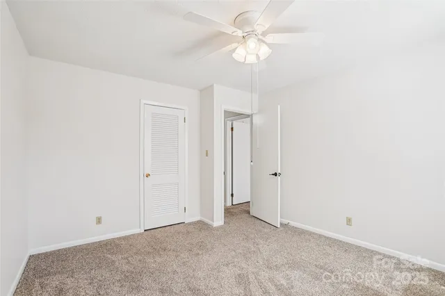 a picture of a room with a white wall and a painting