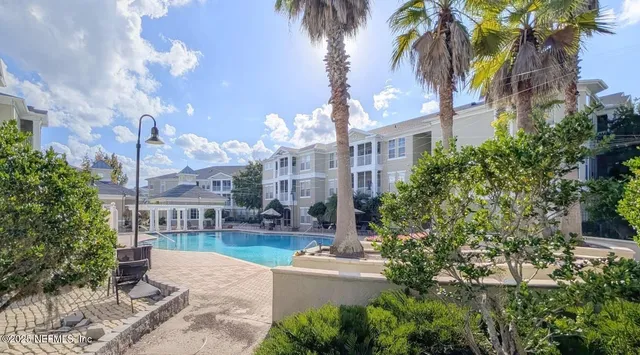 a view of a building with garden and sitting area