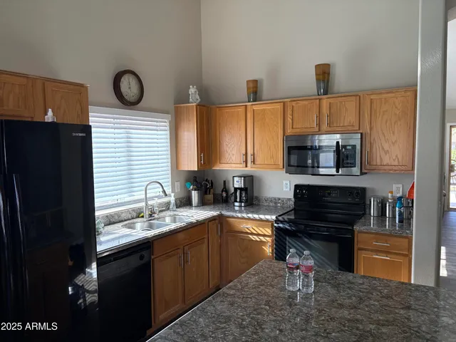 a kitchen with a sink a stove and cabinets