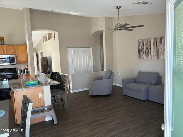 a living room with furniture and a wooden floor