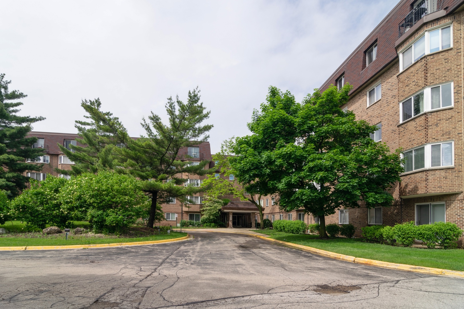 300 South Roselle Road, Unit 319 Schaumburg, IL 60193 - Photo 1 of 11 a front view of a house with a yard and trees