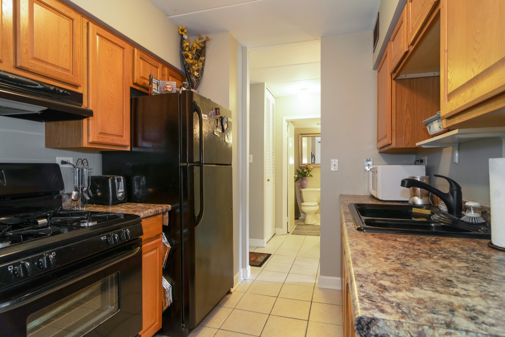 300 South Roselle Road, Unit 319 Schaumburg, IL 60193 - Photo 3 of 11 a kitchen with a refrigerator and a stove top oven