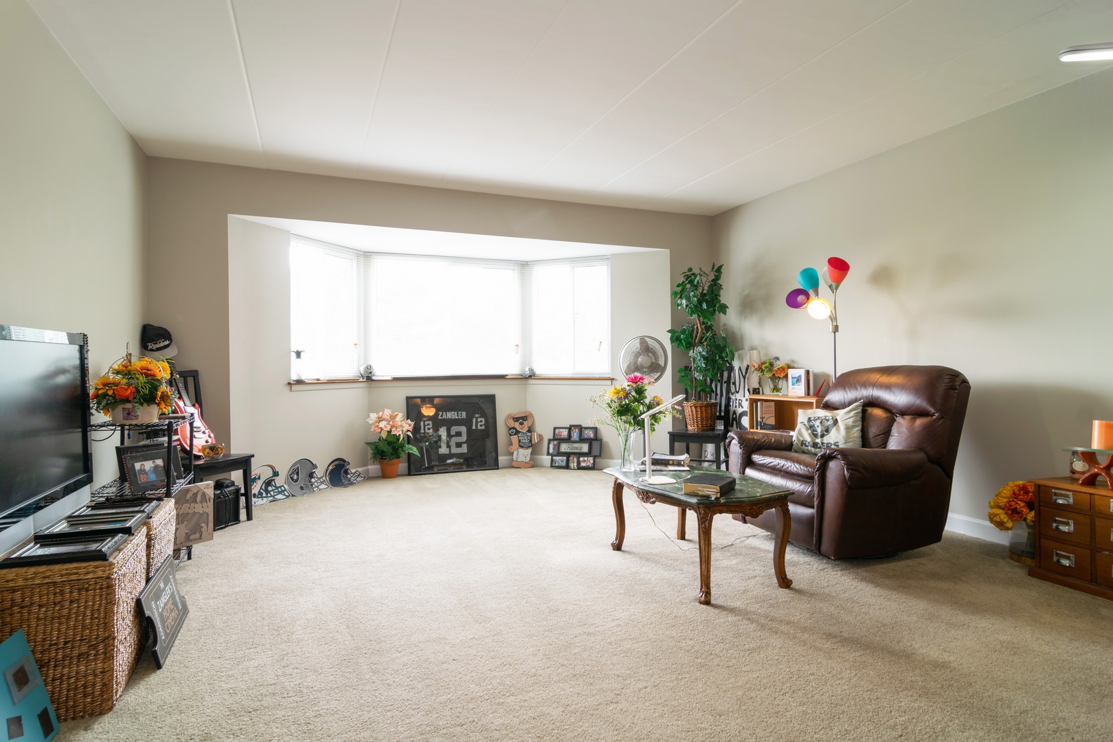 300 South Roselle Road, Unit 319 Schaumburg, IL 60193 - Photo 4 of 11 a living room with furniture a flat screen tv and a fireplace