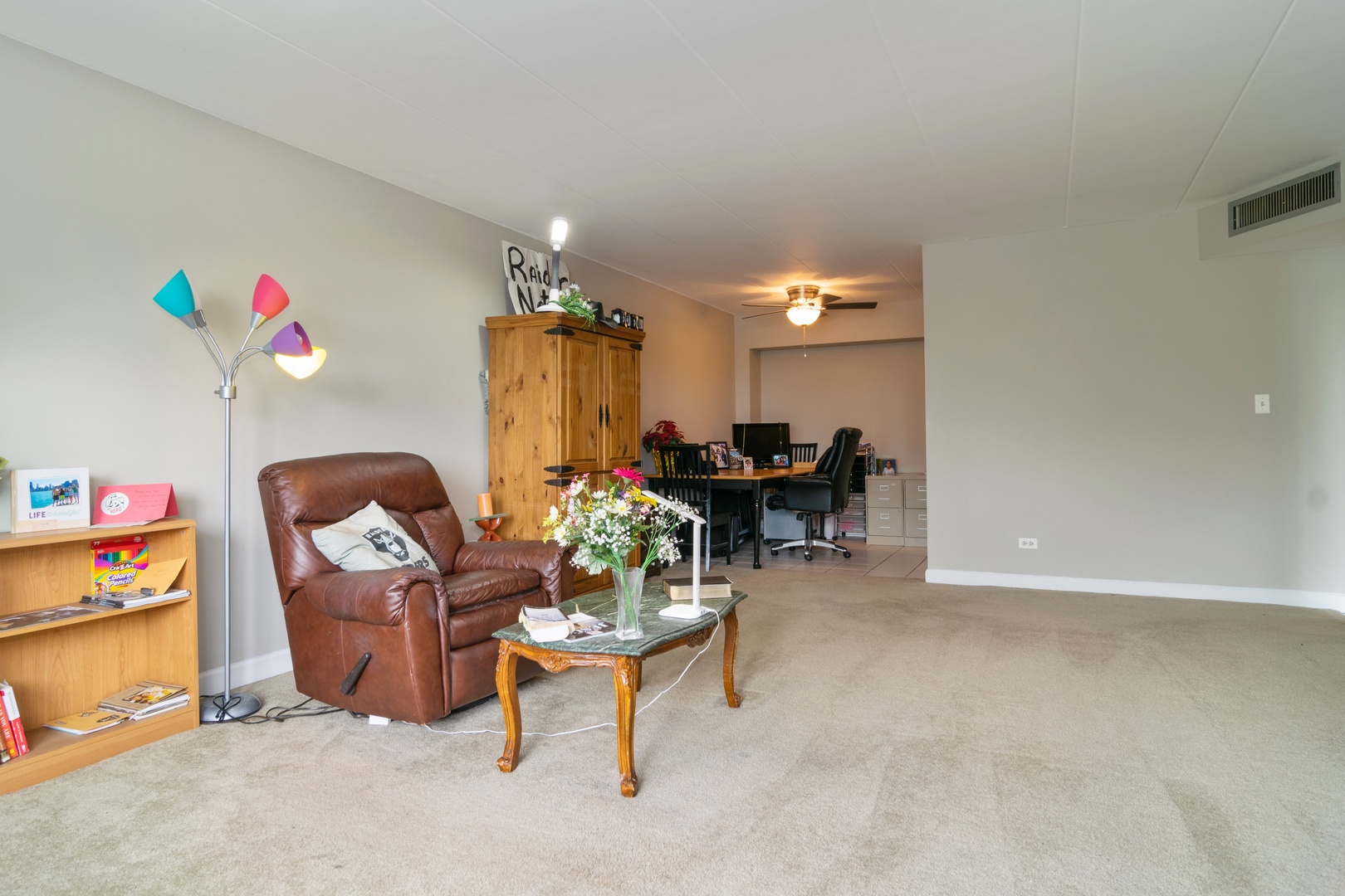 300 South Roselle Road, Unit 319 Schaumburg, IL 60193 - Photo 5 of 11 a living room with furniture and a dining table