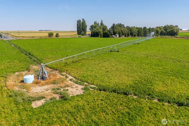 a view of a field with a building in the background