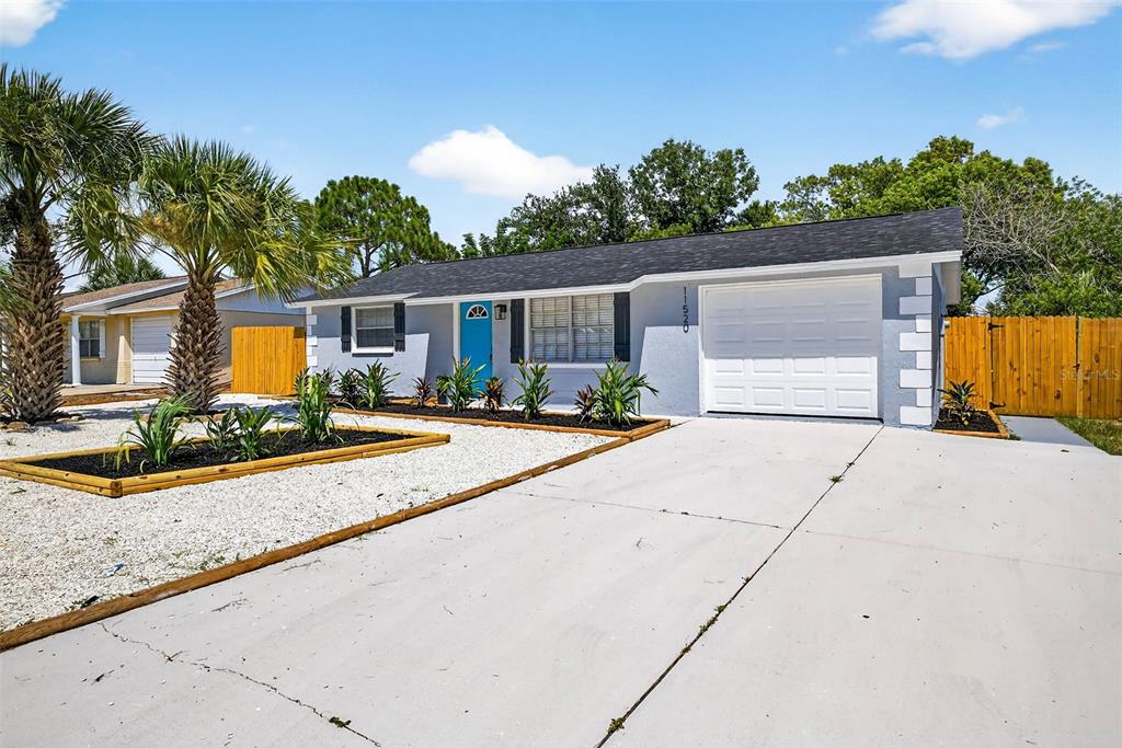 11520 Meadow Drive Port Richey, FL 34668 - Photo 1 of 1 a view of a backyard with plants and palm tree