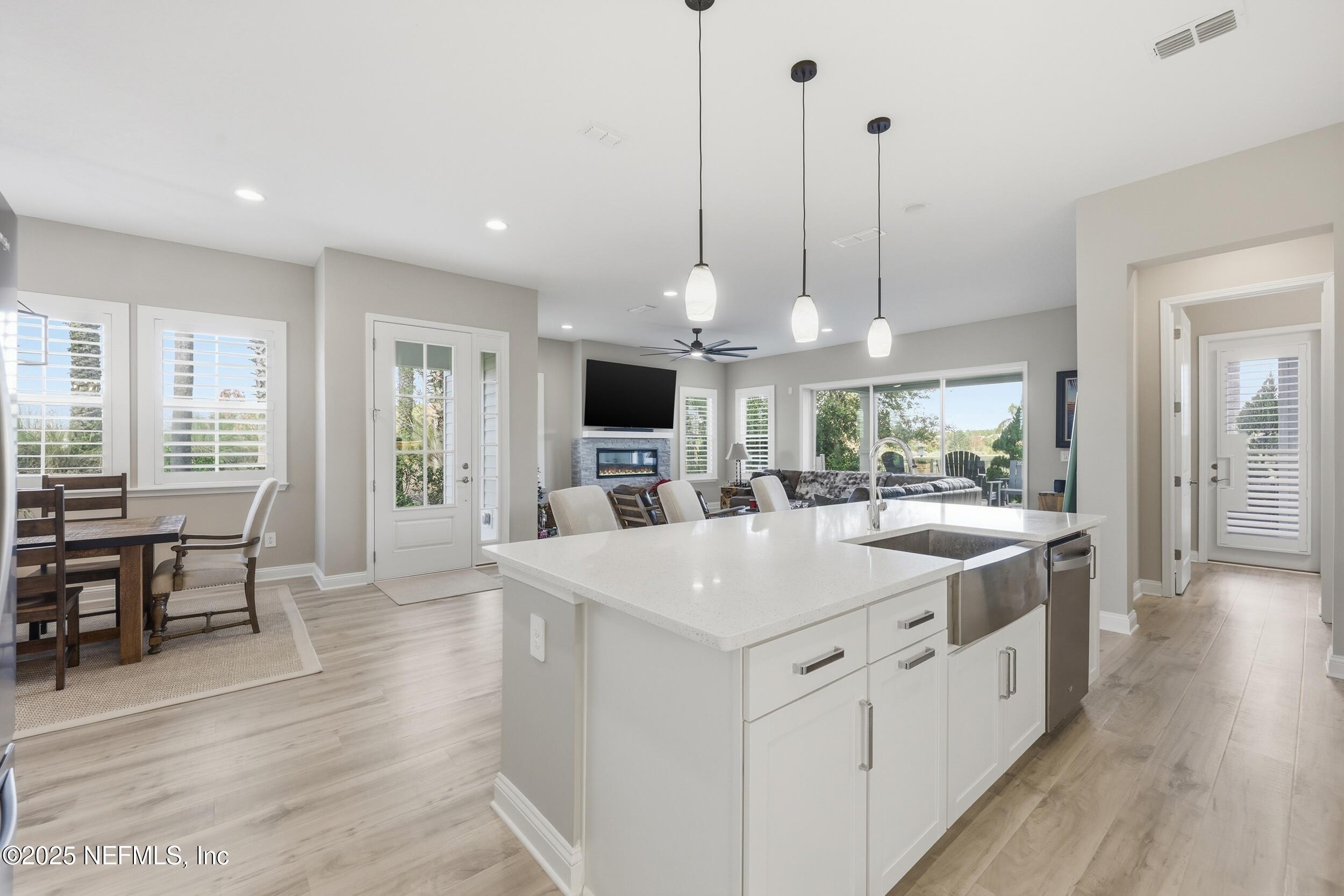 45 Rum Runner Way St. Johns, FL 32259 - Photo 13 of 50 a large kitchen with kitchen island a stove a sink a center island and couches