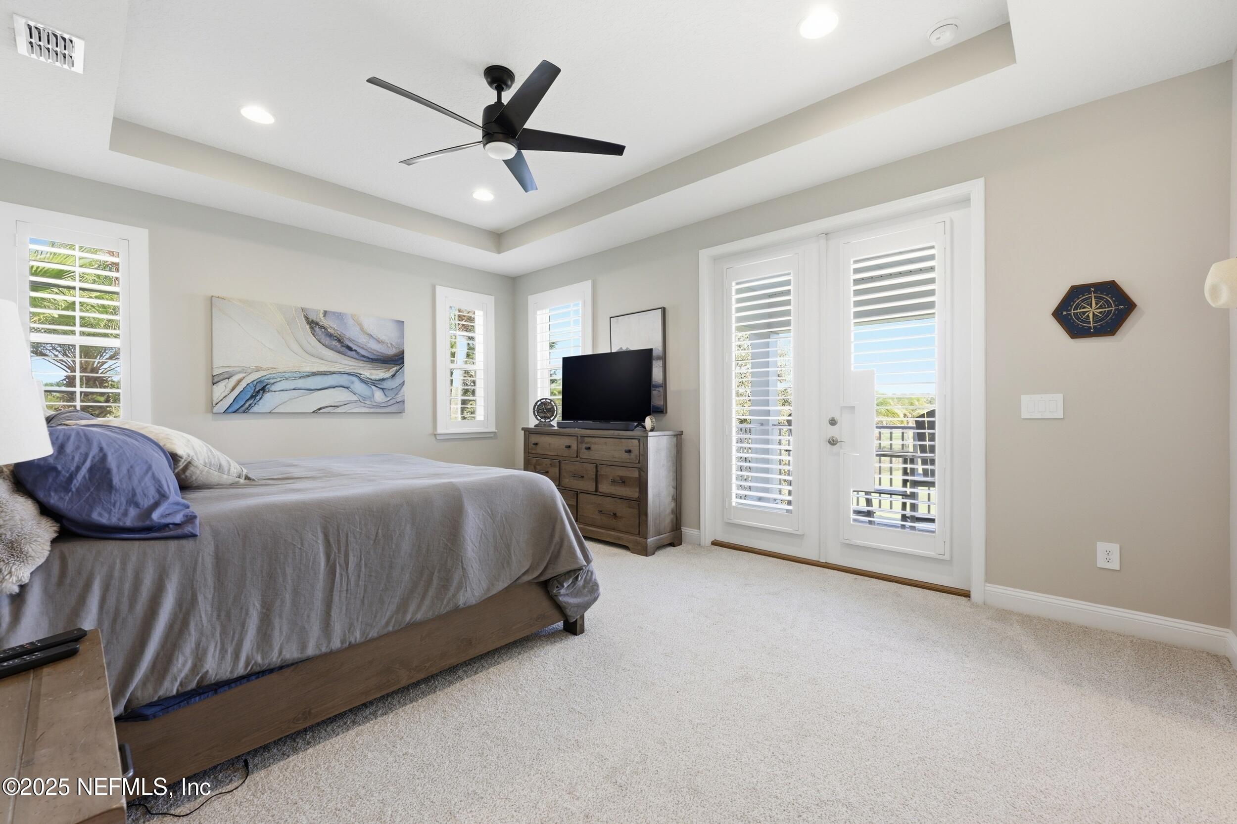 45 Rum Runner Way St. Johns, FL 32259 - Photo 17 of 50 a bedroom with a balcony a bed furniture and a window