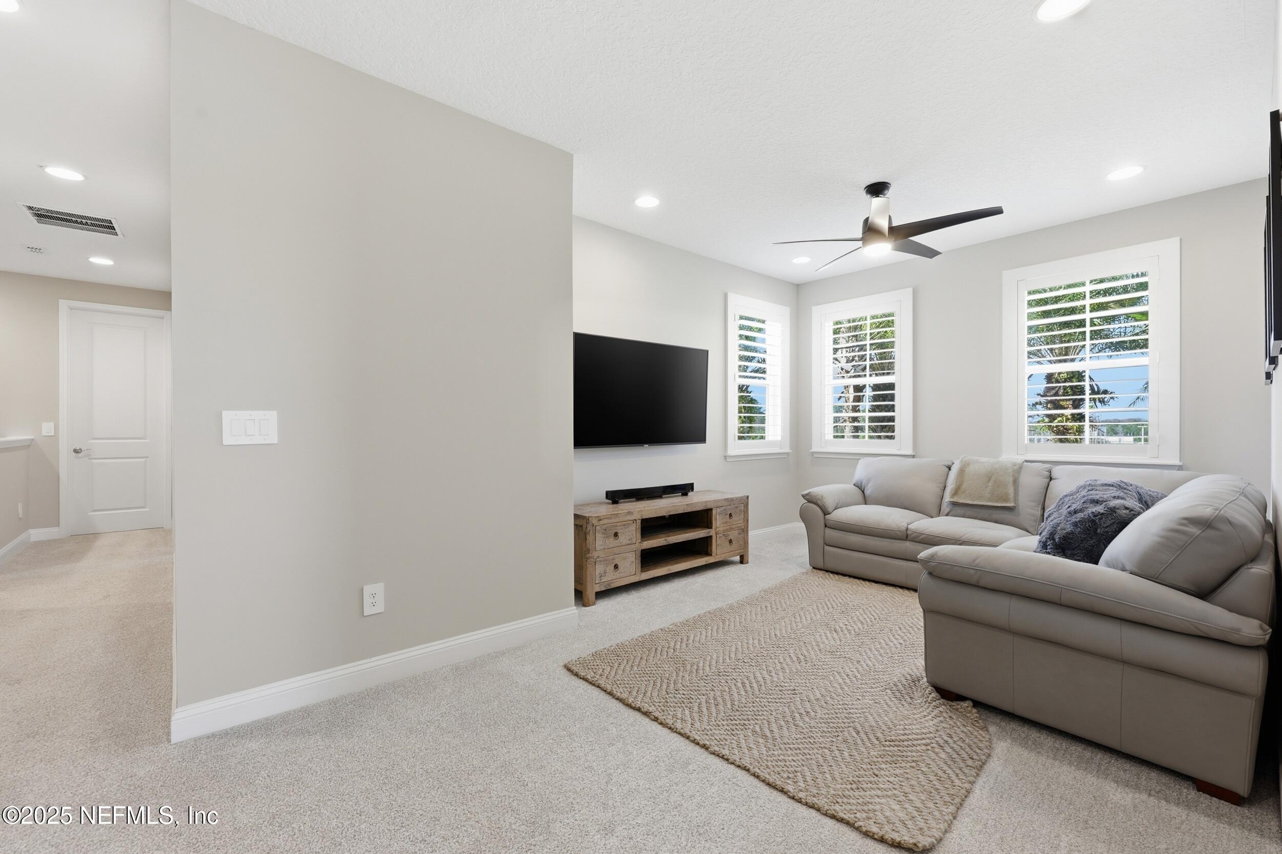 45 Rum Runner Way St. Johns, FL 32259 - Photo 21 of 50 a living room with furniture and a flat screen tv
