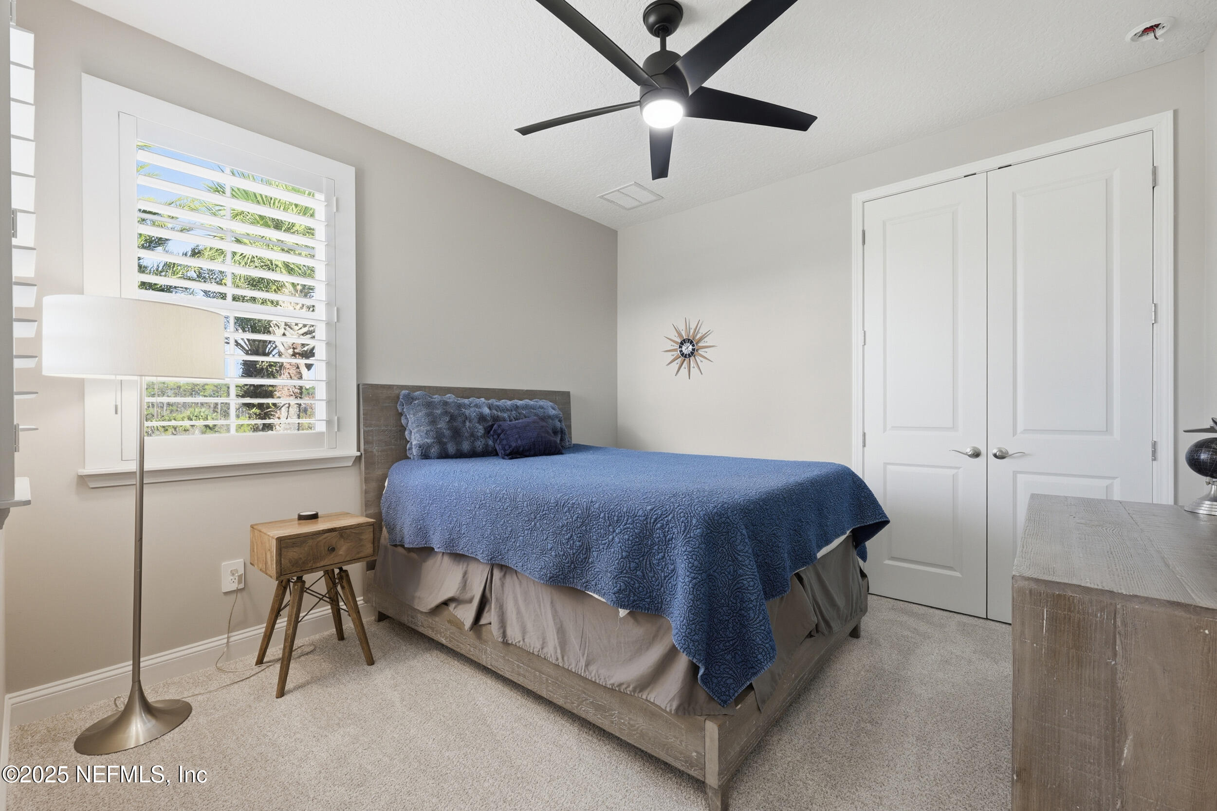 45 Rum Runner Way St. Johns, FL 32259 - Photo 22 of 50 a spacious bedroom with a bed and a chandelier