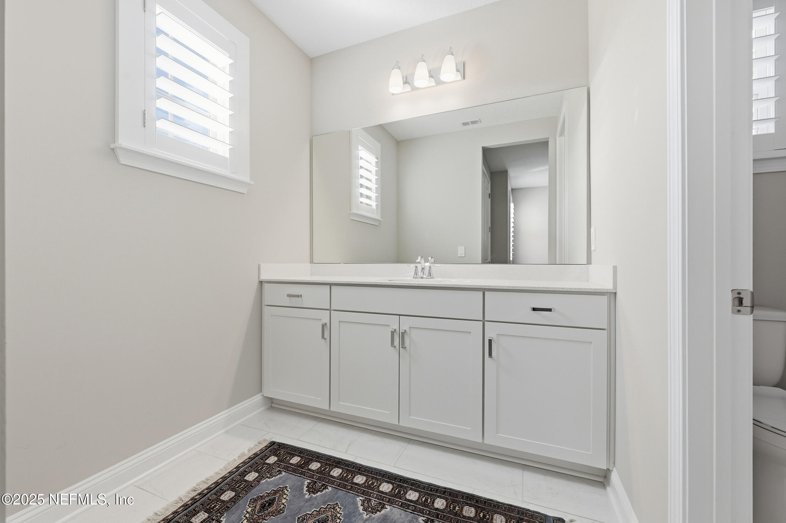 45 Rum Runner Way St. Johns, FL 32259 - Photo 25 of 50 a bathroom with a sink and a mirror