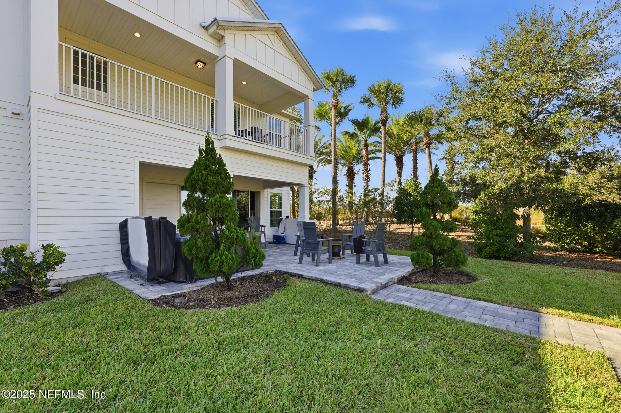 45 Rum Runner Way St. Johns, FL 32259 - Photo 32 of 50 a view of a chair and tables in the back yard of the house