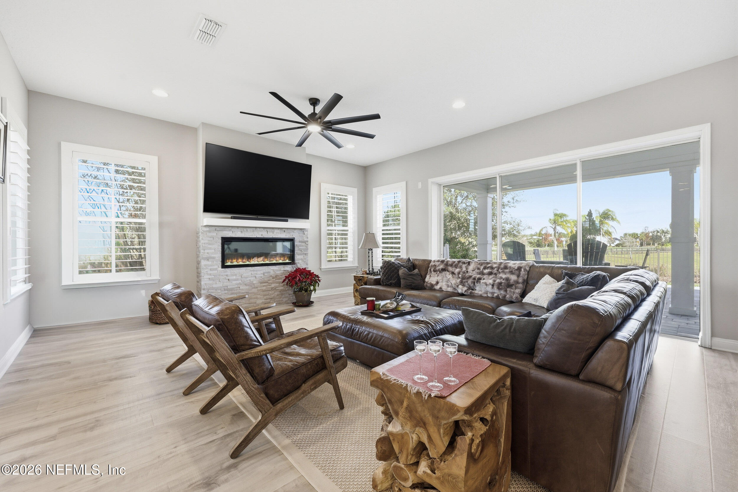 45 Rum Runner Way St. Johns, FL 32259 - Photo 8 of 50 a living room with furniture a flat screen tv and a fireplace