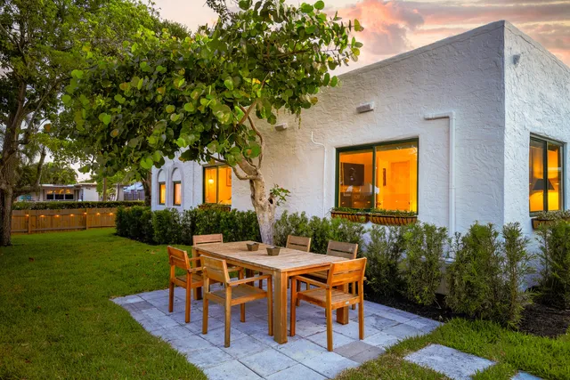 a view of a house with backyard sitting area and garden