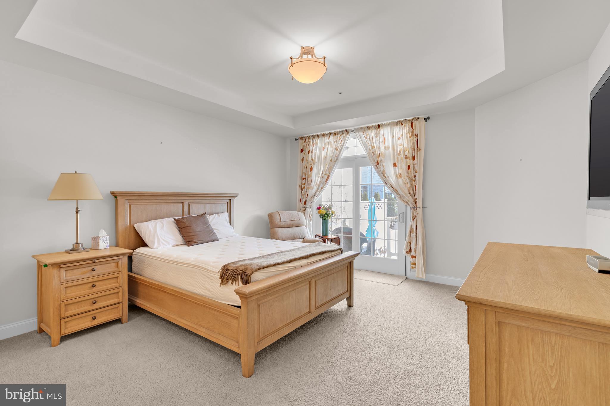 8781 Endless Ocean Way, Unit 58 Columbia, MD 21045 - Photo 21 of 74 a bed room with a bed and a lamp