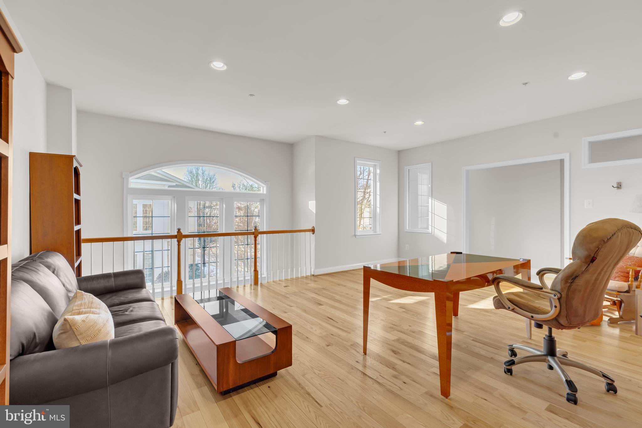 8781 Endless Ocean Way, Unit 58 Columbia, MD 21045 - Photo 31 of 74 a living room with furniture and a table