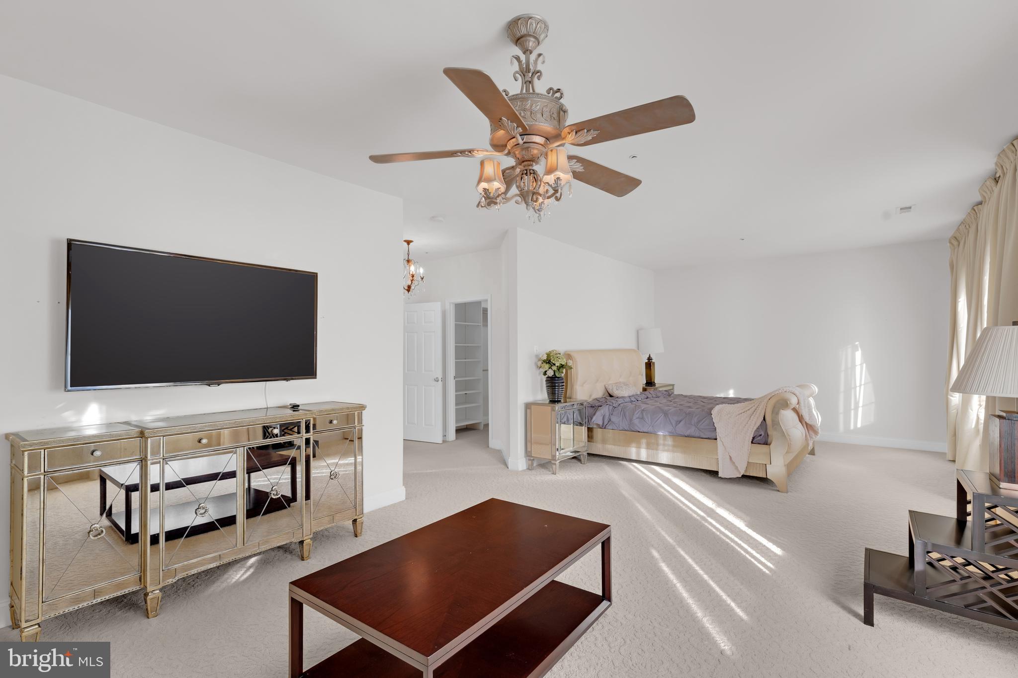 8781 Endless Ocean Way, Unit 58 Columbia, MD 21045 - Photo 37 of 74 a living room with furniture and a flat screen tv
