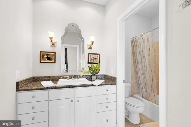 a view of a patio with couches table and chairs and potted plants
