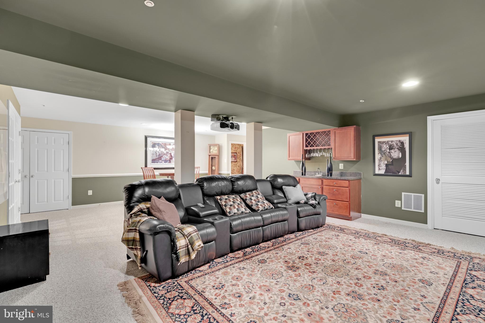 8781 Endless Ocean Way, Unit 58 Columbia, MD 21045 - Photo 57 of 74 a living room with furniture and a rug