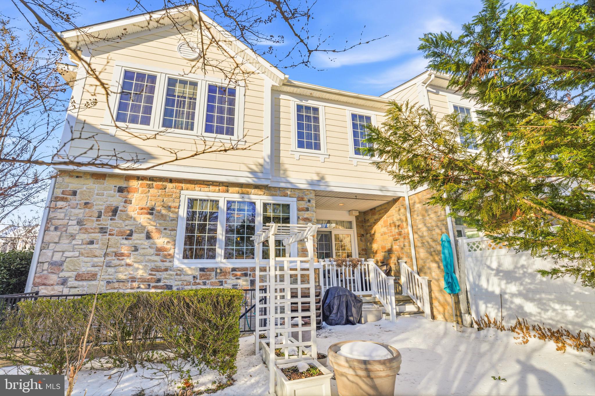 8781 Endless Ocean Way, Unit 58 Columbia, MD 21045 - Photo 64 of 74 a view of a patio with couches table and chairs and potted plants