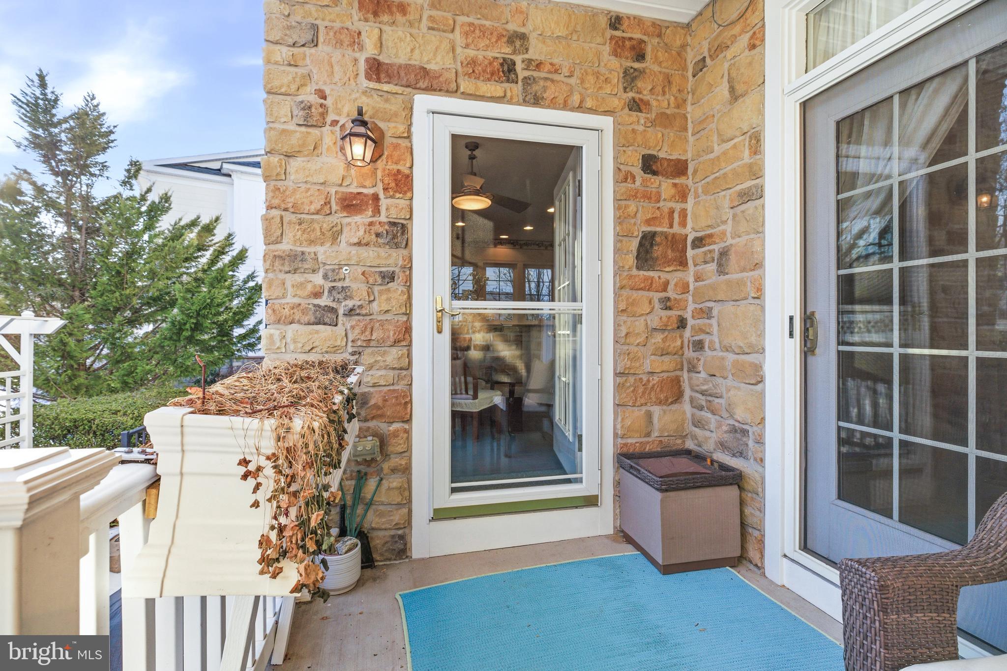 8781 Endless Ocean Way, Unit 58 Columbia, MD 21045 - Photo 67 of 74 a view of a brick house with a potted plant and a large window