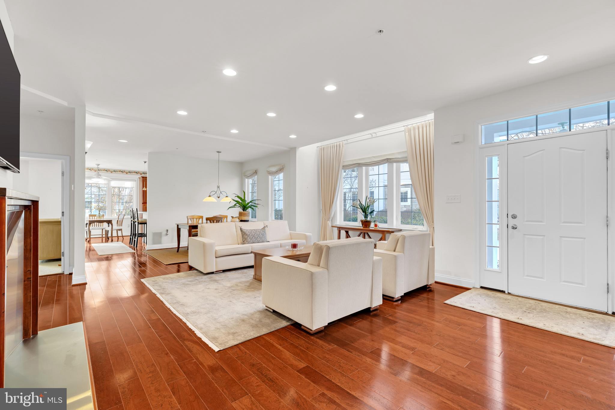 8781 Endless Ocean Way, Unit 58 Columbia, MD 21045 - Photo 10 of 74 a living room with fireplace furniture and a wooden floor