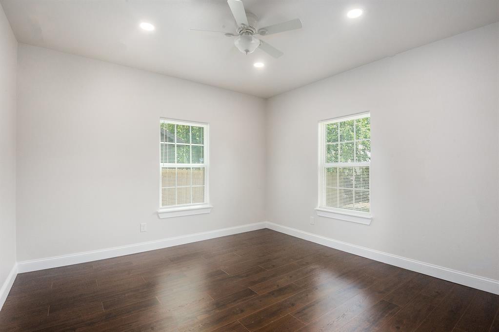 290 Aurora Street Rhome, TX 76078 - Photo 15 of 17 an empty room with wooden floor and windows