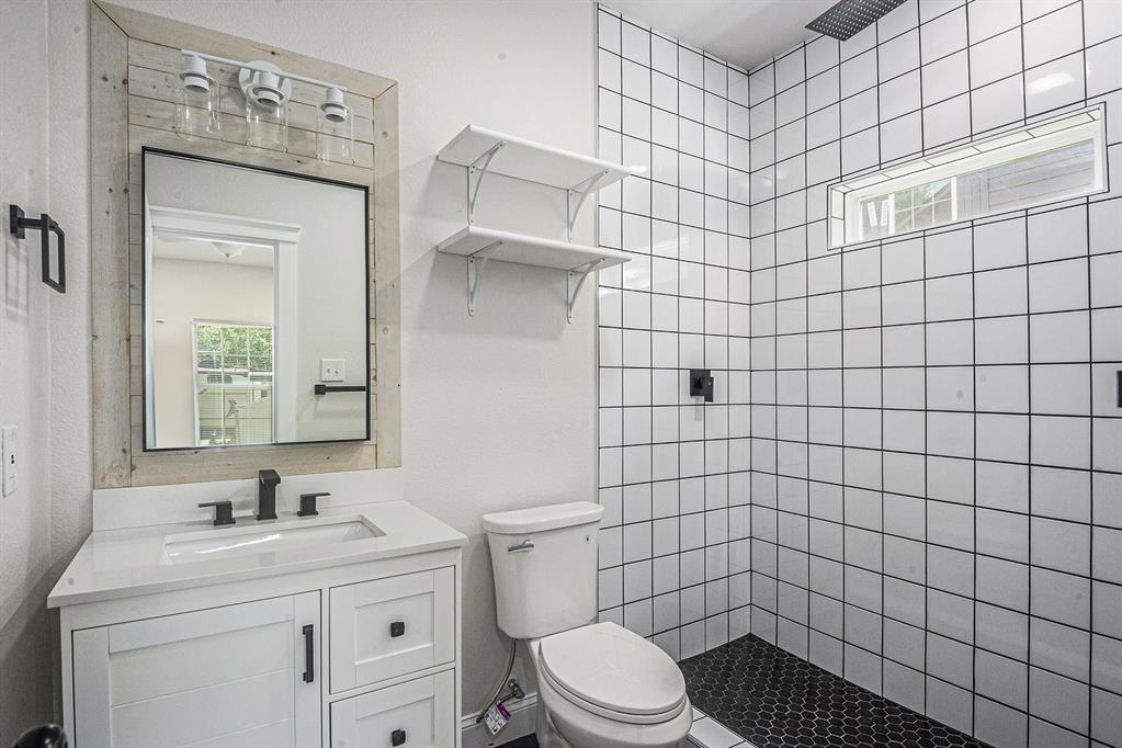 290 Aurora Street Rhome, TX 76078 - Photo 16 of 17 a bathroom with a sink a toilet and shower