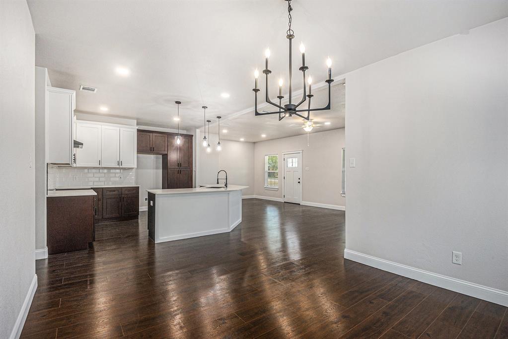 290 Aurora Street Rhome, TX 76078 - Photo 6 of 17 a view of large kitchen with kitchen island stainless steel appliances sink and wooden floor