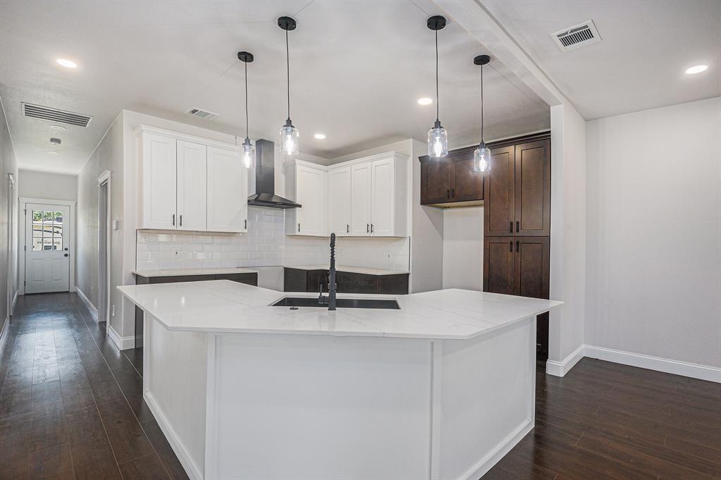 290 Aurora Street Rhome, TX 76078 - Photo 8 of 17 a kitchen with stainless steel appliances granite countertop a sink a stove and a refrigerator