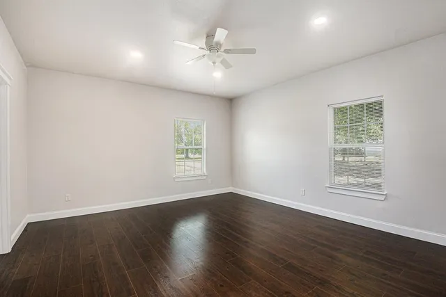 a view of an empty room with wooden floor