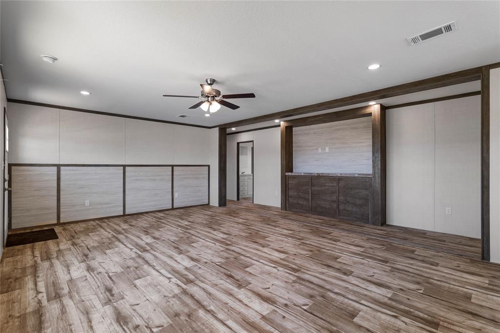 3924 Sandusky Road Whitesboro, TX 76273 - Photo 4 of 22 Unfurnished bedroom with light wood-style floors, ceiling fan, a decorative wall, recessed lighting, and crown molding