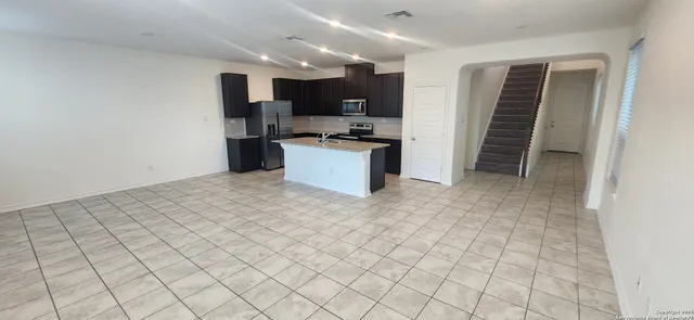 a kitchen with stainless steel appliances a refrigerator and a sink