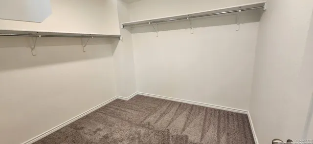a view of a hallway with closet and wooden floor