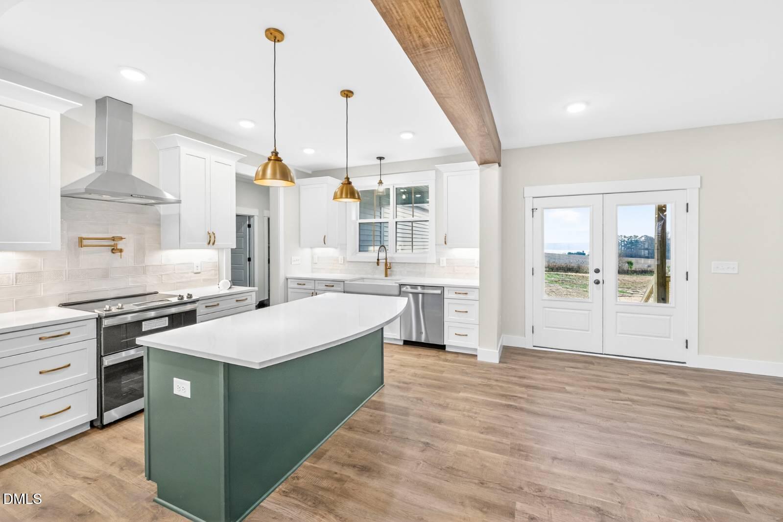 8 Trey Point Dr Spring Spring Hope, NC 27882 - Photo 7 of 31 a large kitchen with stainless steel appliances kitchen island granite countertop a sink a stove and a wooden floors