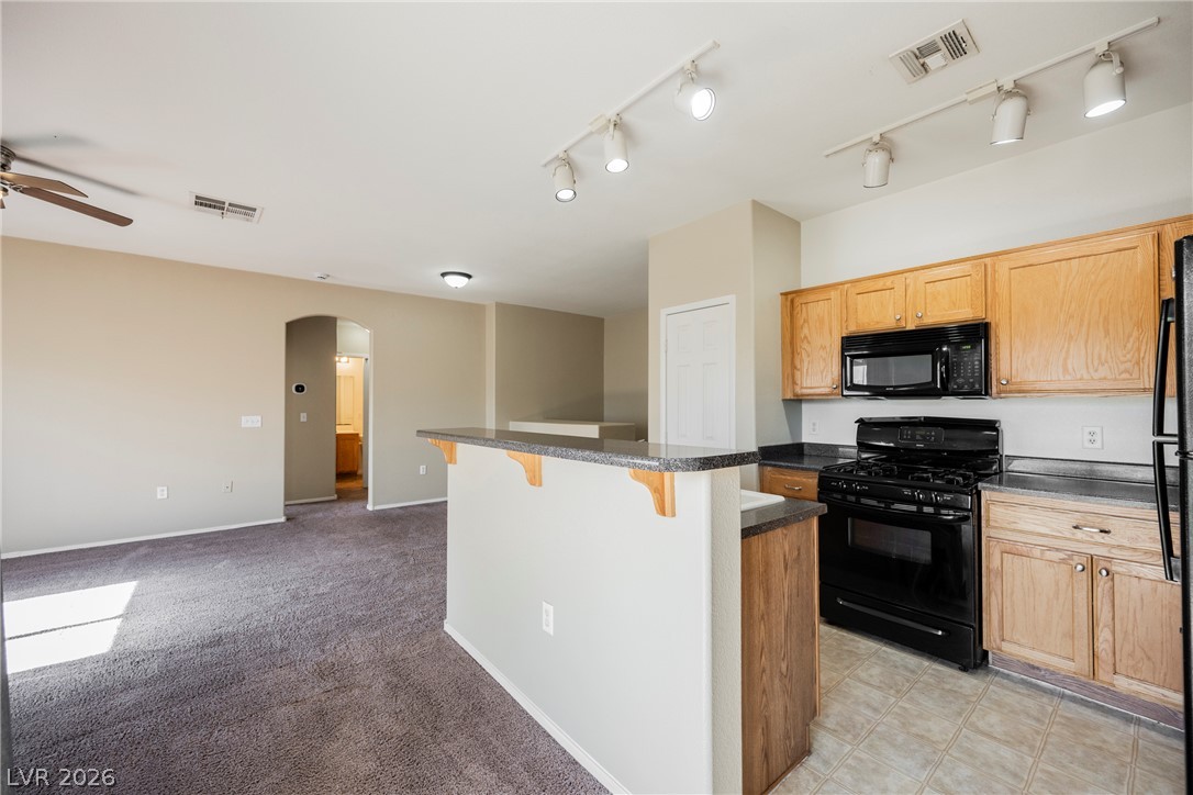 6320 Snap Ridge Street, Unit 201 North Las Vegas, NV 89081 - Photo 56 of 56 An open floor plan seamlessly connects the kitchen and living area, ideal for relaxed entertaining.