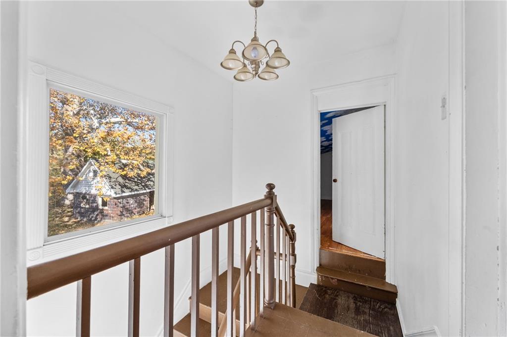 797 Carlton Drive Bentleyville, PA 15314 - Photo 13 of 24 a view of a hallway with wooden floor and a chandelier
