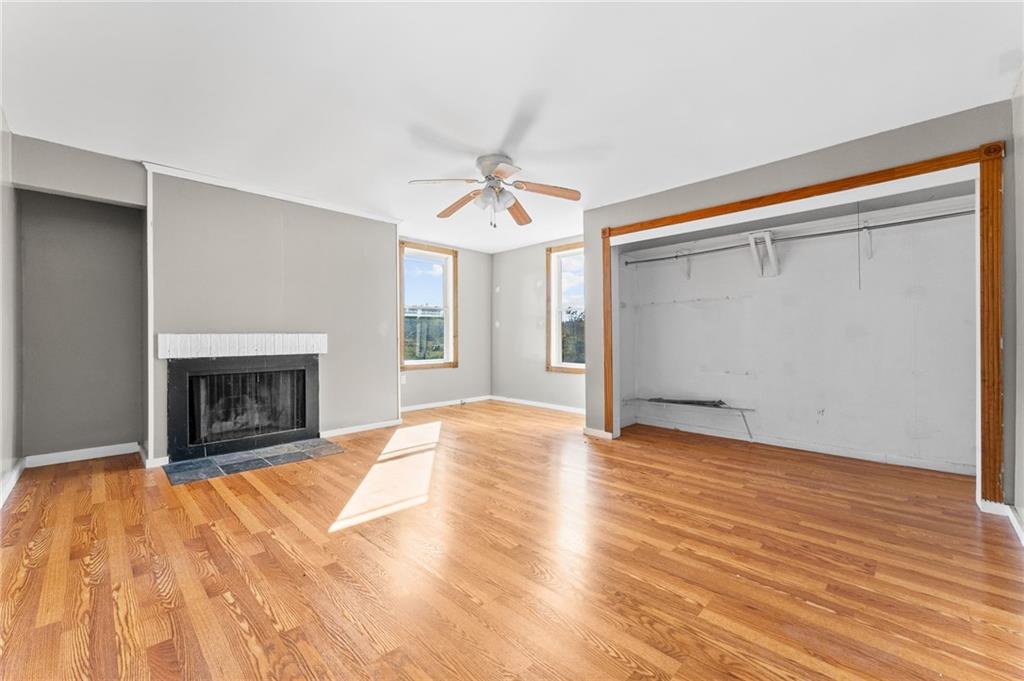 797 Carlton Drive Bentleyville, PA 15314 - Photo 15 of 24 a view of an empty room with wooden floor fireplace and a window