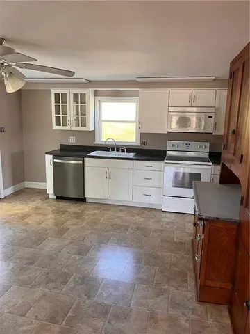 a kitchen with stainless steel appliances granite countertop a stove and a sink