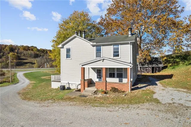 a view of a house with a yard