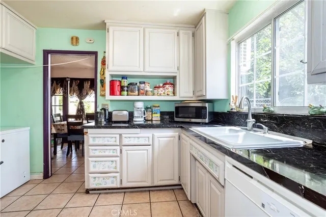 a bedroom with a large bed and a flat tv screen on the dresser