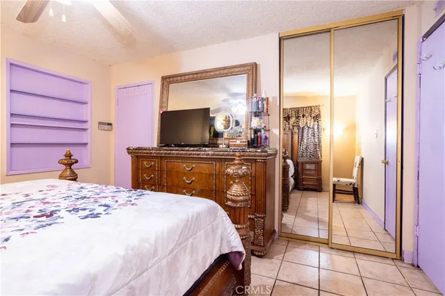 a bathroom with a granite countertop sink and a toilet