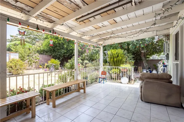 a view of a house with backyard and sitting area