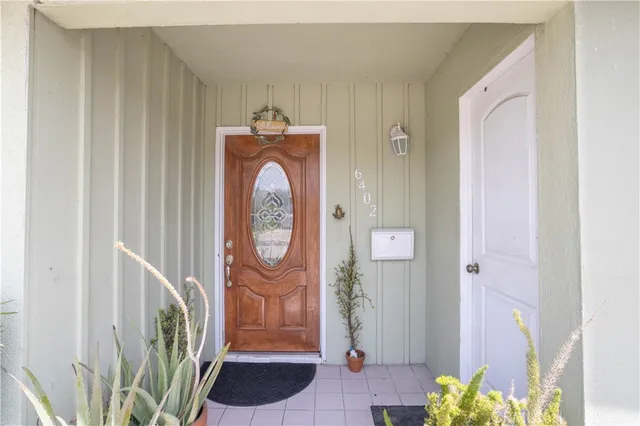 a dining room with furniture a chandelier and window