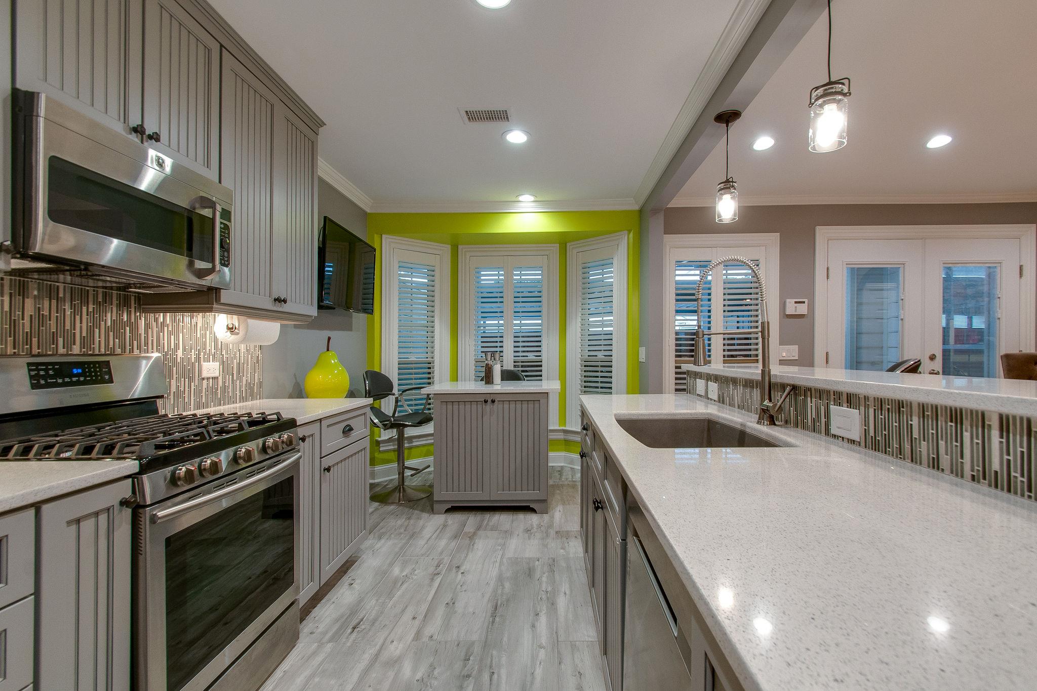 731 General George Patton Road Nashville, TN 37221 - Photo 9 of 19 a kitchen with stainless steel appliances granite countertop a stove a sink and a microwave