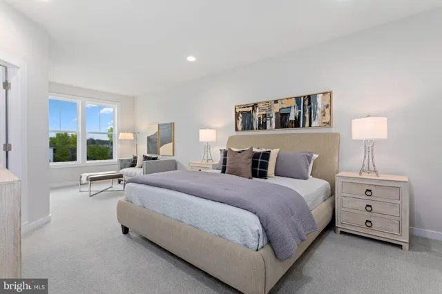 a spacious bedroom with a bed and a couch