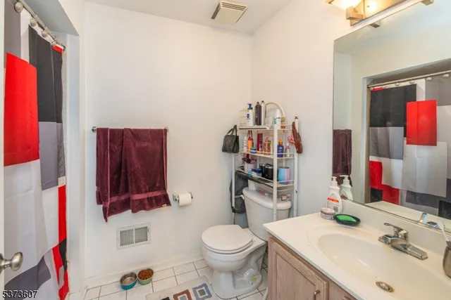 a bathroom with a sink vanity mirror and toilet