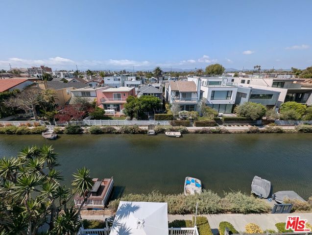 an aerial view of a house with a yard and seating space