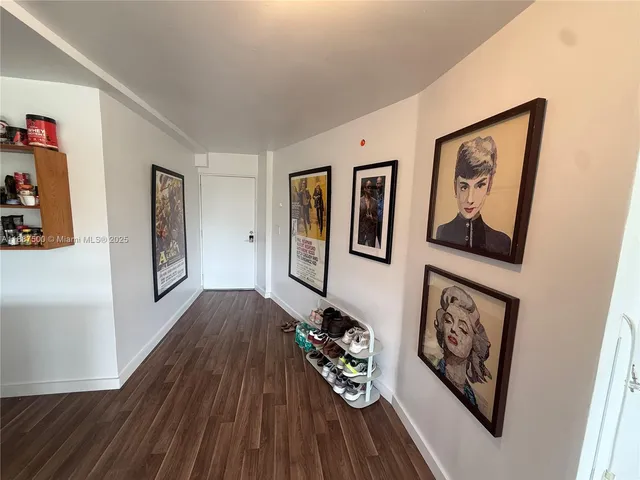a view of a hallway with wooden floor and closet