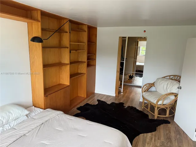 a bedroom with a bed and chair